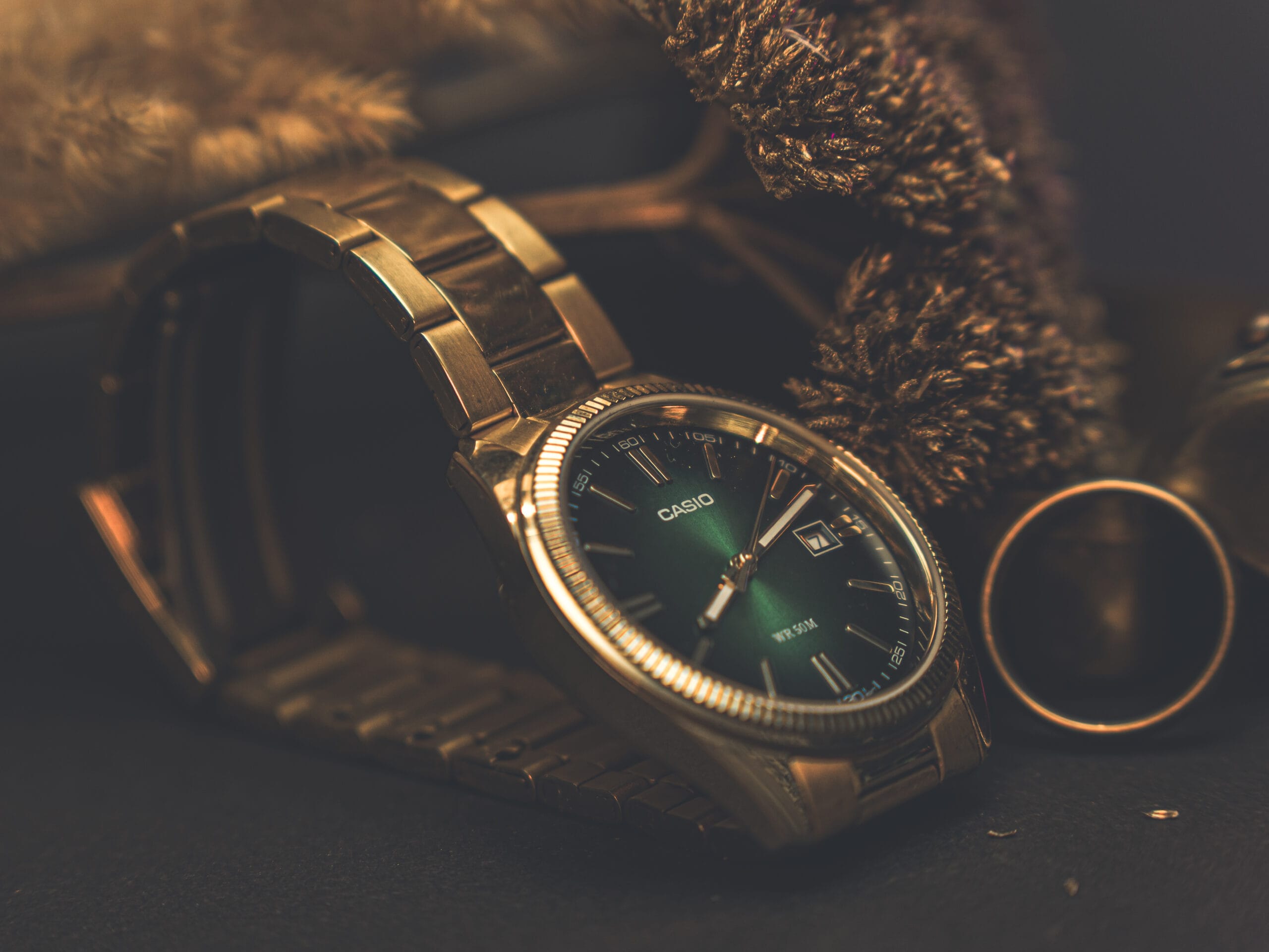 Złoty zegarek Casio z ciemną tarcza otoczony suszonymi dodatkami – Obiektywni Studio